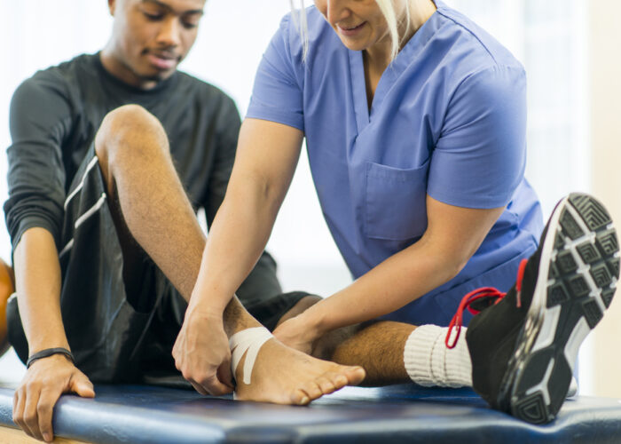 An athlete receiving rehibilitative care for a sports injury.